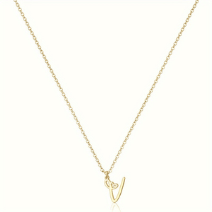 Gold necklace with a heart-shaped pendant on a white background