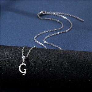 Silver necklace with a 'G' pendant on a black and blue background