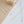 Gold and silver necklaces with letter pendants on a light gray background