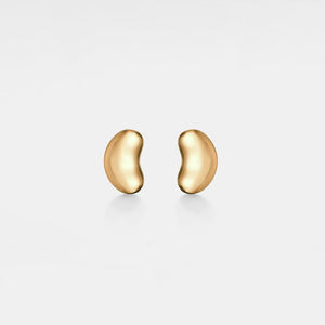 Pair of gold bean-shaped earrings on a light gray background