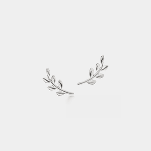 Silver leaf-shaped earrings on a light gray background