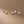 Four pairs of gold and silver earrings on a brown background