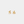 Pair of gold star-shaped earrings on a light gray background
