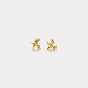 Pair of gold star-shaped earrings on a light gray background