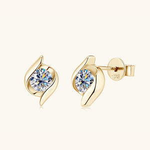 Gold earrings with clear gemstones on a white background