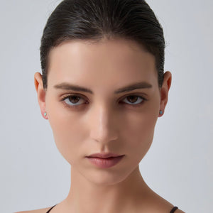 Close-up of a woman's face with a neutral expression on a gray background