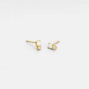 Gold earrings with small diamonds on a white background