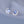 Pair of silver earrings with blue gemstones on a light gray background