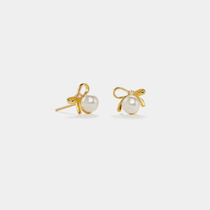 Gold earrings with pearl studs on a white background