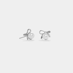 Pair of pearl stud earrings on a light gray background