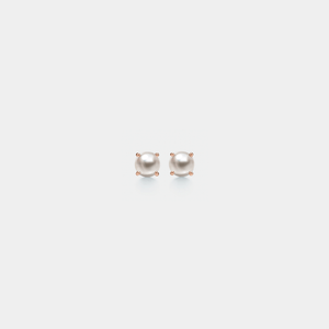 Pair of pearl stud earrings on a light gray background