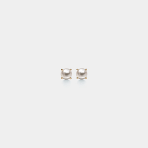 Pair of pearl stud earrings on a light gray background
