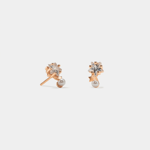 A pair of gold-plated sterling silver stud earrings featuring a pearl with cubic zirconia accents designed to resemble stars.