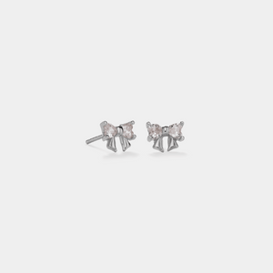 Pair of silver stud earrings with clear gemstones on a light gray background