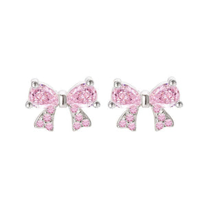 A set of bow tie stud earrings in pink and silver colors, made with sterling silver and cubic zirconia, displayed against a white background.