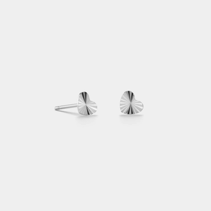 A pair of small heart-shaped stud earrings with gold plating on a white background.