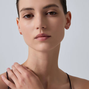 Close-up of a woman's face with a neutral expression on a light gray background