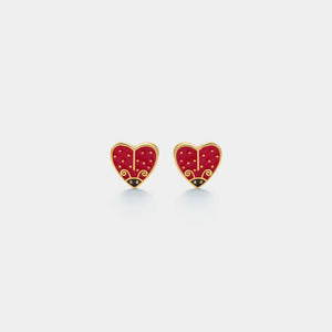 Red heart-shaped earrings with gold accents on a light gray background