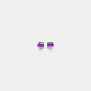A pair of dainty amethyst stud earrings with gold plating on a white background.