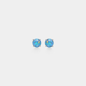 Pair of blue opal stud earrings on a light gray background