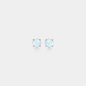 Pair of opal stud earrings on a light gray background