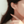 Close-up of a person wearing a sea turtle earring with a blurred background