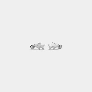 Shark-shaped earrings on a light gray background