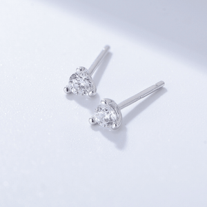 Pair of silver stud earrings with clear gemstones on a light gray background