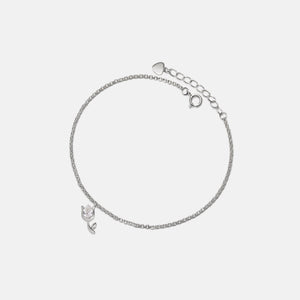 A gold-plated sterling silver bracelet with a small tulip flower charm and adjustable chain.