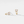 Gold earrings with clear gemstones on a light gray background