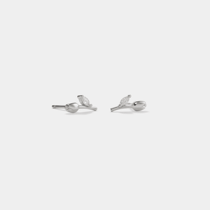 A pair of small tulip-shaped stud earrings with gold plating and cubic zirconia stones.