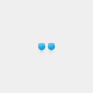 Pair of turquoise stud earrings on a light gray background