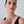 Woman wearing a black sleeveless top against a plain background