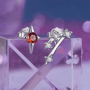 Silver earrings with gemstones on a purple and pink gradient background