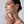 Woman touching her face with a neutral background
