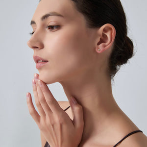 Woman touching her face with a neutral background