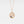 A gold-plated necklace with a sterling silver Tree of Life pendant and a blue cubic zirconia at the center, displayed on a white background.