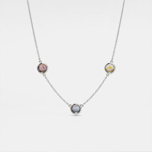 A gold-plated necklace with three circular photo projection pendants on a white background.