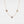 A gold-plated necklace with three circular photo projection pendants on a white background.