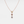 A silver necklace with gold plating featuring three round crystal glass pendants in a gradient of colors, suspended from a gold-plated chain.