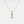 A silver necklace with gold plating featuring three round crystal glass pendants in a gradient of colors, suspended from a gold-plated chain.