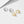 Two pairs of hoop earrings, one silver and one gold, on a light background.