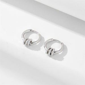 A set of hoop earrings in two different finishes, silver and gold, displayed against a neutral background.