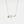 Gold necklace with a pendant on a white background
