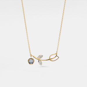 Gold necklace with a pendant on a white background