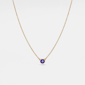 Gold necklace with a blue evil eye pendant on a white background