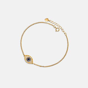 Gold bracelet with a decorative clasp on a light gray background