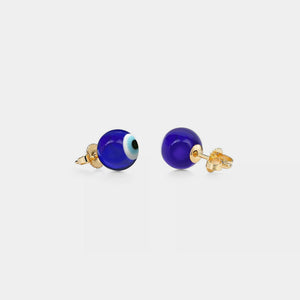 A pair of stud earrings featuring a blue 'evil eye' design on a white background