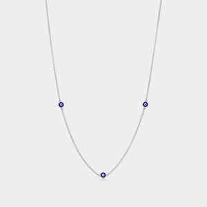 A gold-plated necklace with three blue enamel charms representing the evil eye, designed to be worn around the neck.