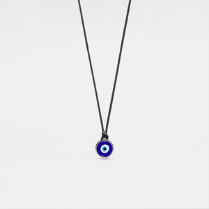 A Turkish evil eye necklace with a blue enamel charm on a black rope chain.